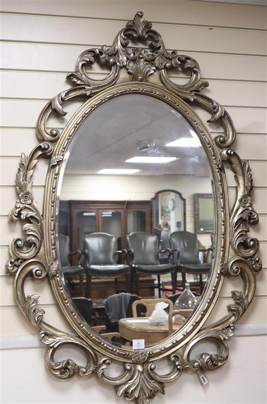 A Victorian style silvered frame oval wall mirror H.138cm